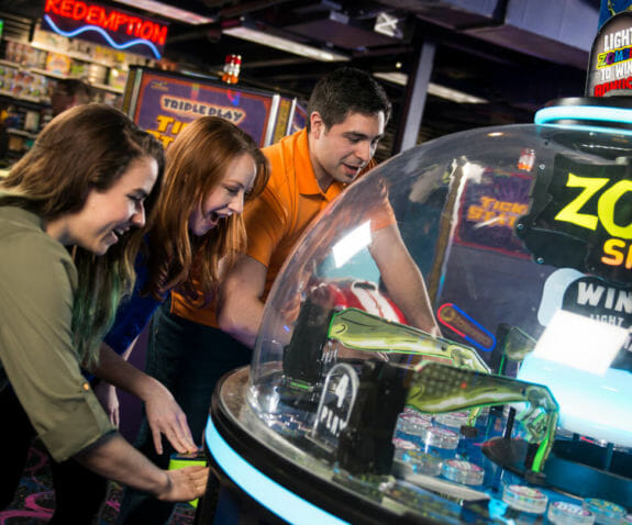 Adults playing an arcade game