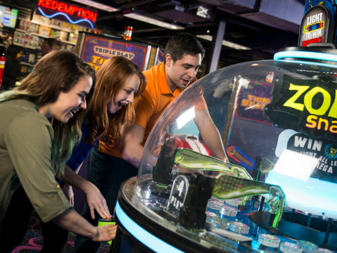 Adults playing an arcade game