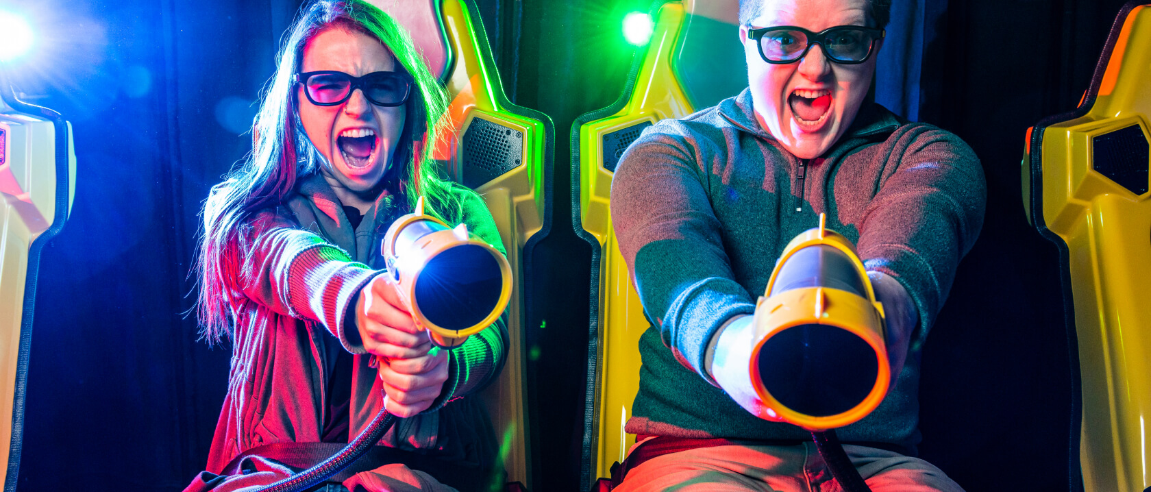 Close up of two adults on the XD Dark ride screaming