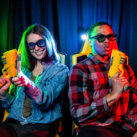 Close up of two adults smiling on the XD Dark ride