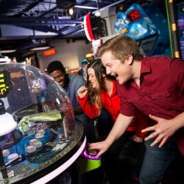 Group of adults playing an arcade game