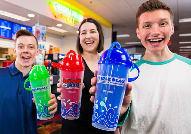 Three adults holding up their Triple Play souvenir cups