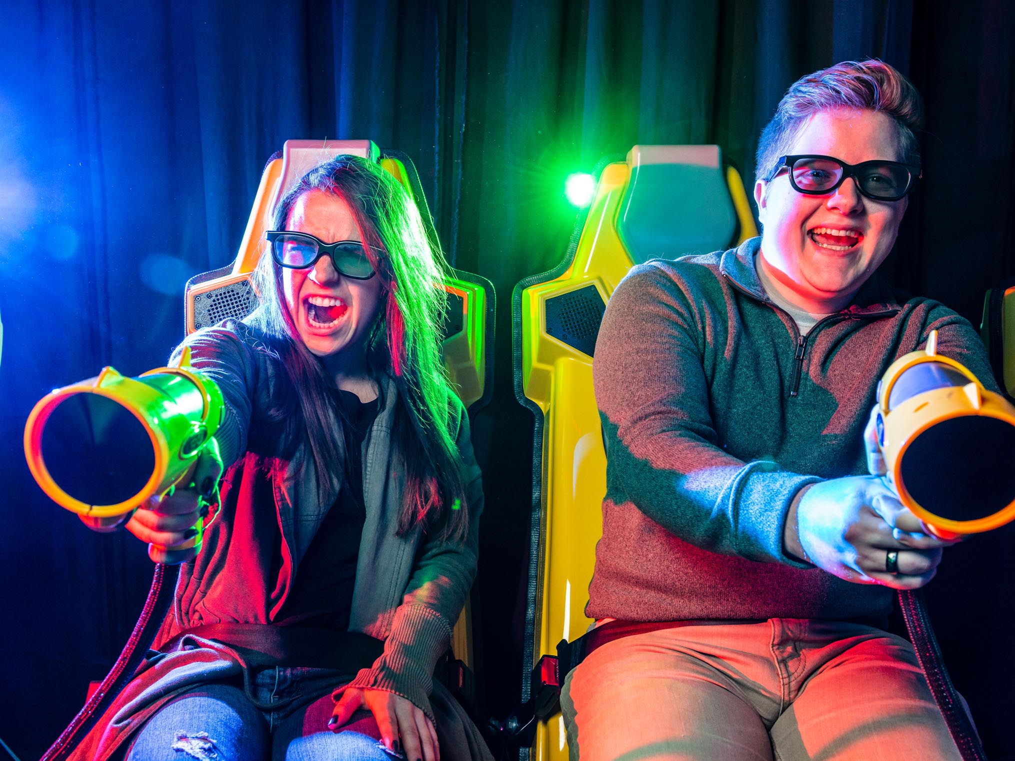 Two young adults shooting on the XD dark ride