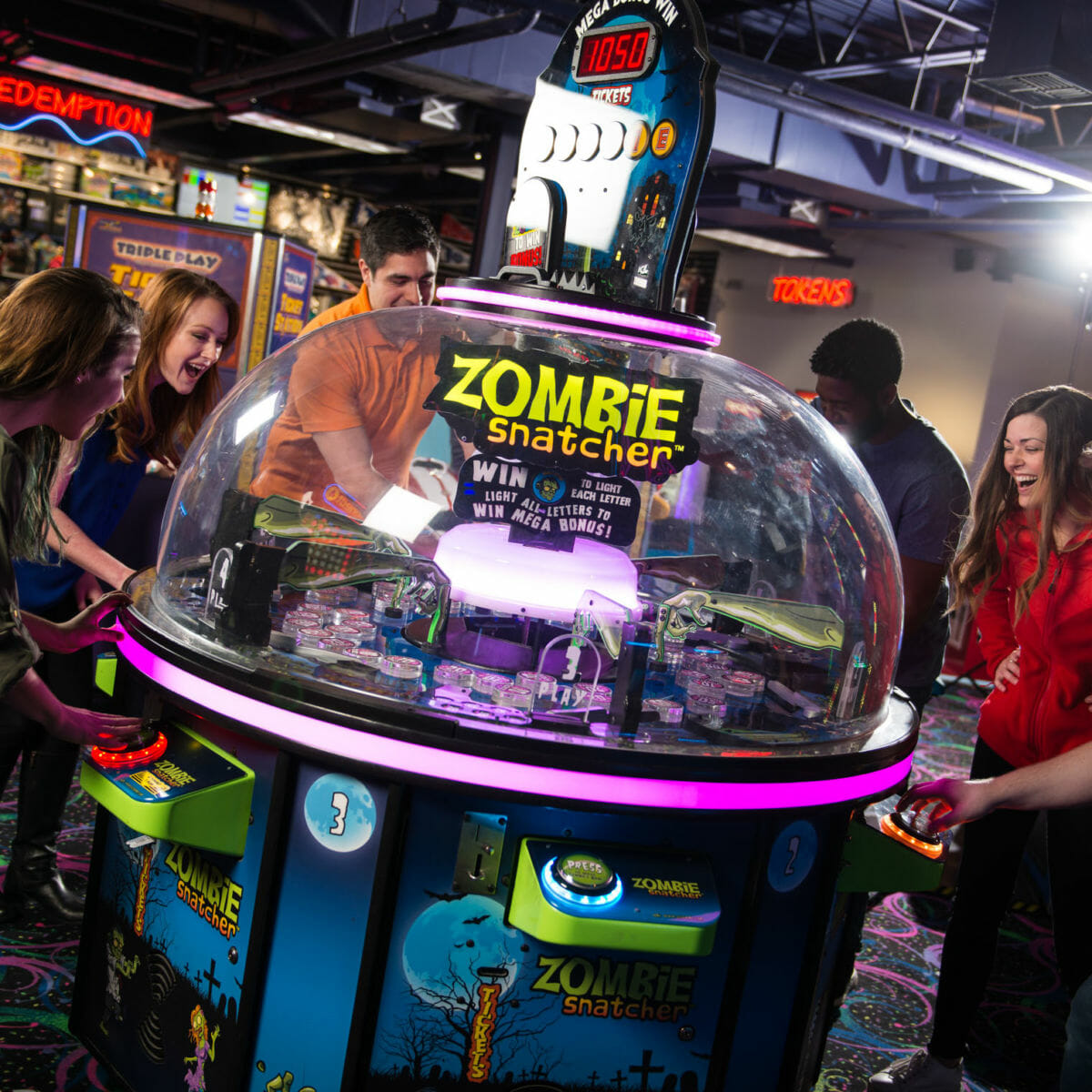 Group of young adults playing an arcade game