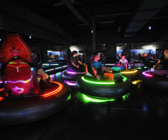 Adults and kids riding bumper cars