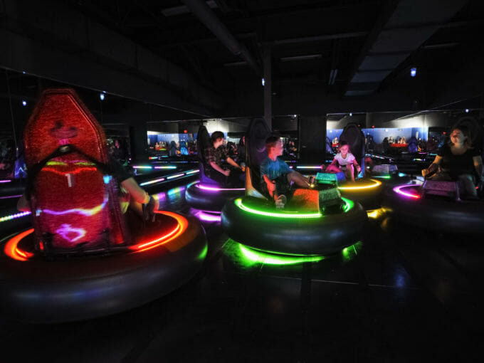 Adults and kids riding bumper cars