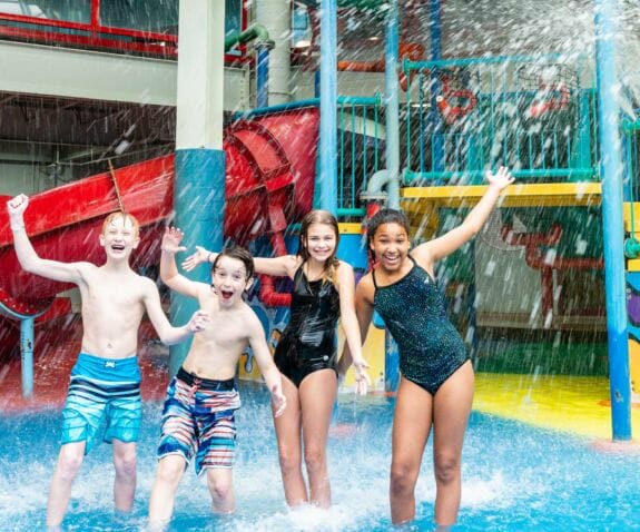 Four young friends in the aquaplay area