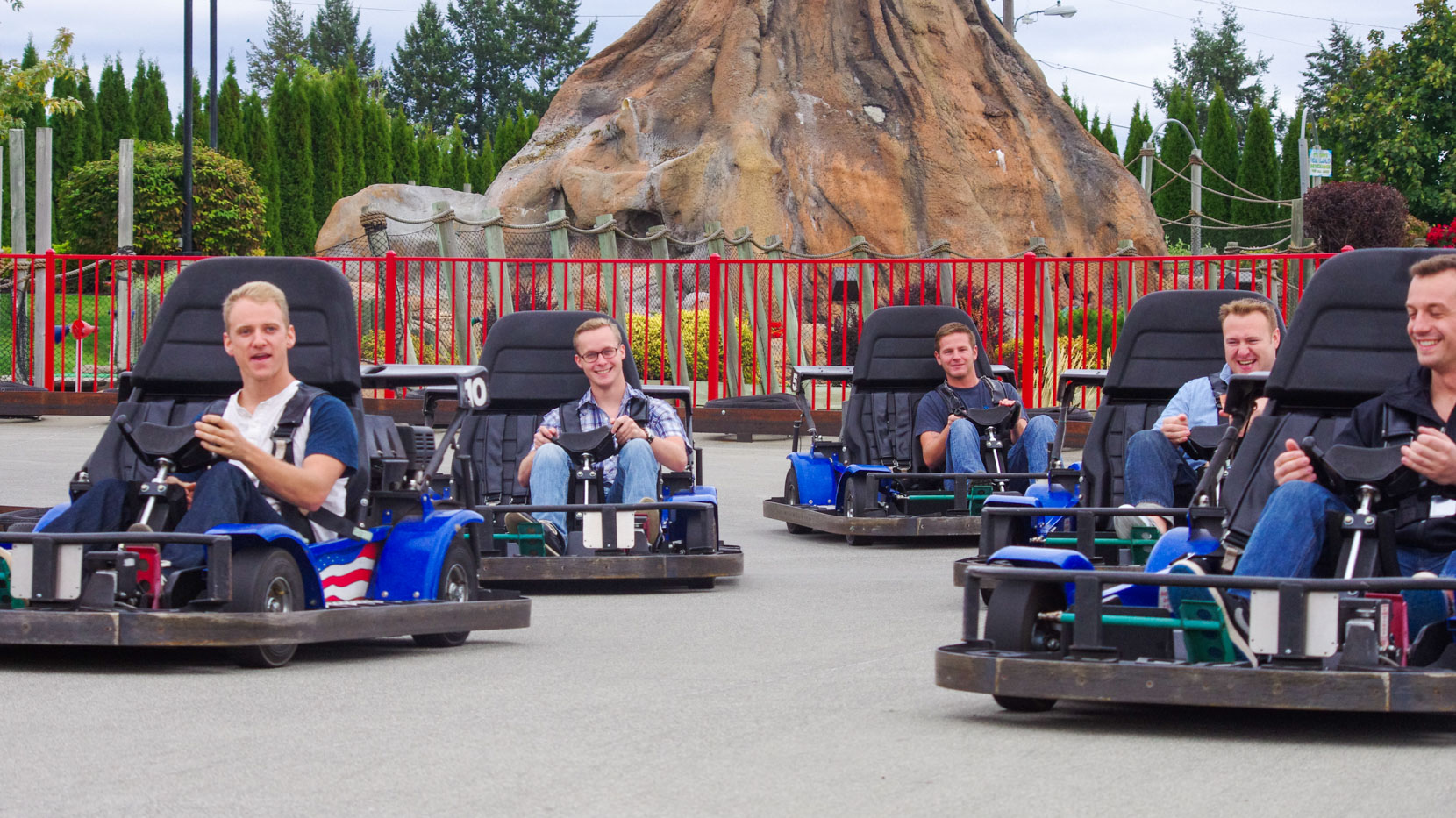 Group of young professionals racing on the Go Kart track