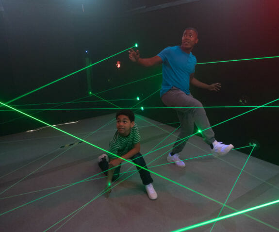 Father and son navigating the laser maze