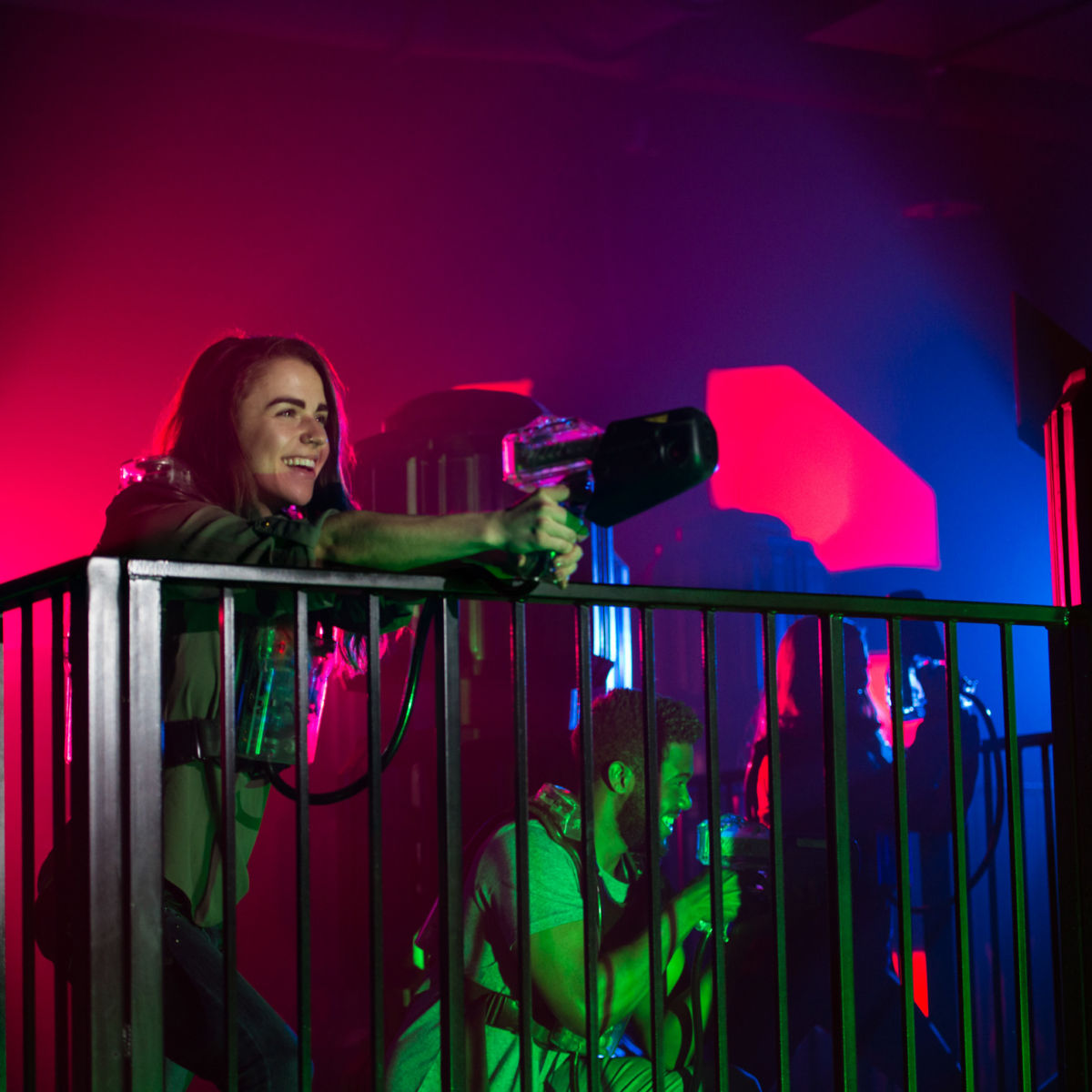 Young woman playing laser tag