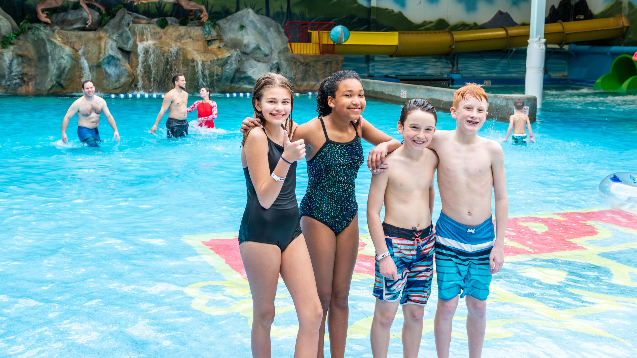 Group of young kids standing together in the raptor reef wave pool